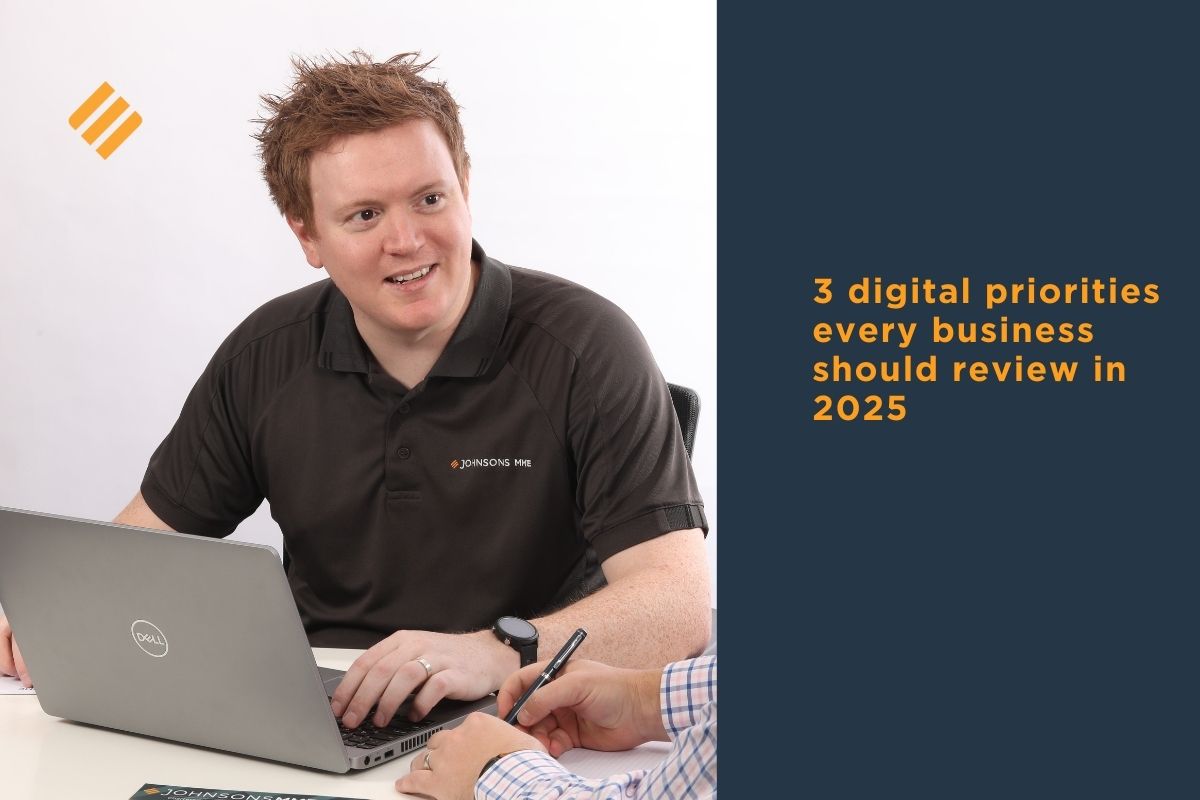 Johnsons MME adviser meeting with a business client, discussing business digital priorities with a laptop open on the desk.