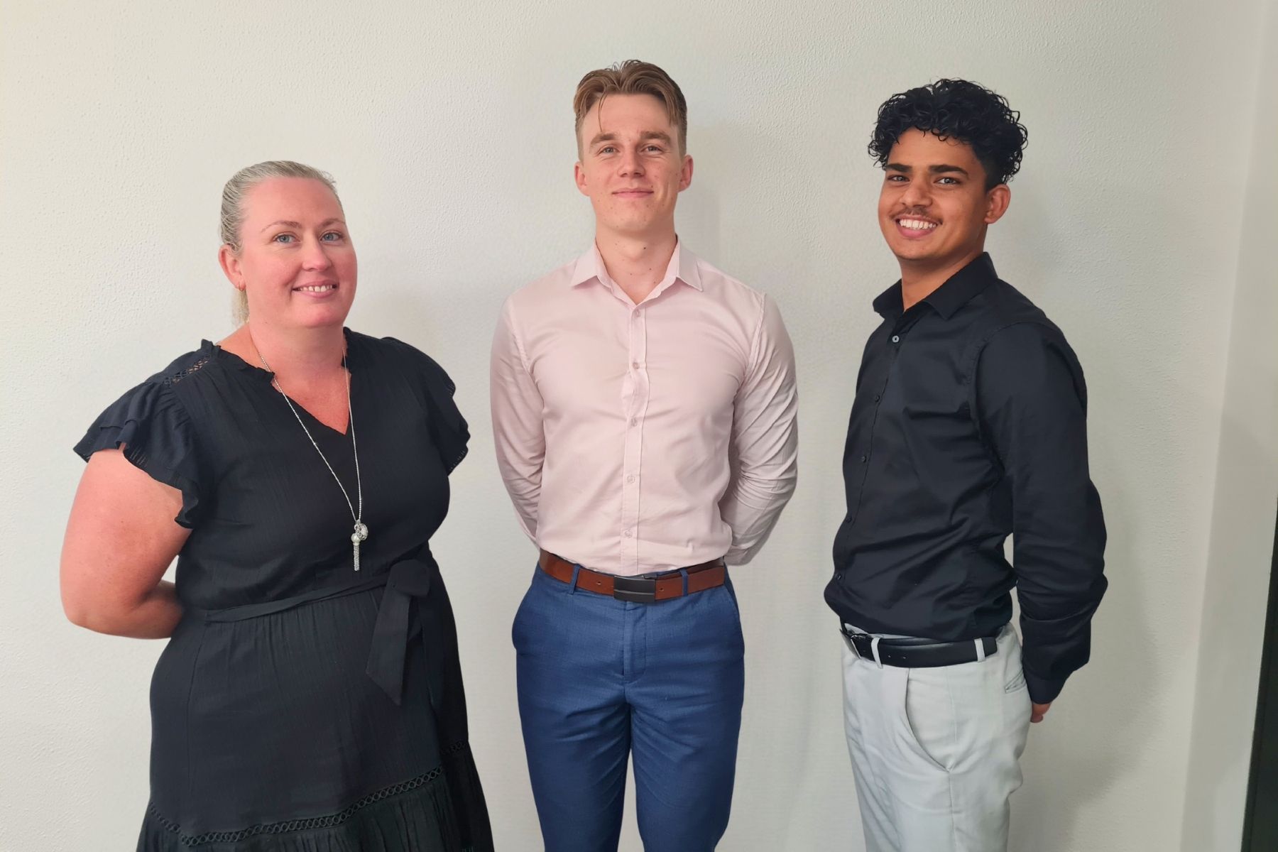 Three Johnsons MME team members standing together and smiling, reflecting the firm’s values and culture of professionalism, collaboration, and approachability.