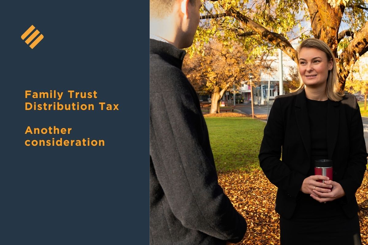 Business advisor discussing Family Trust Distribution Tax considerations with a client outdoors