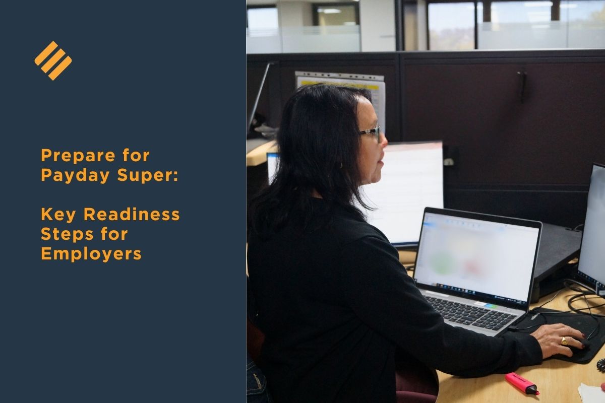Employer preparing for Payday Super changes while working at desk with laptop in office environment