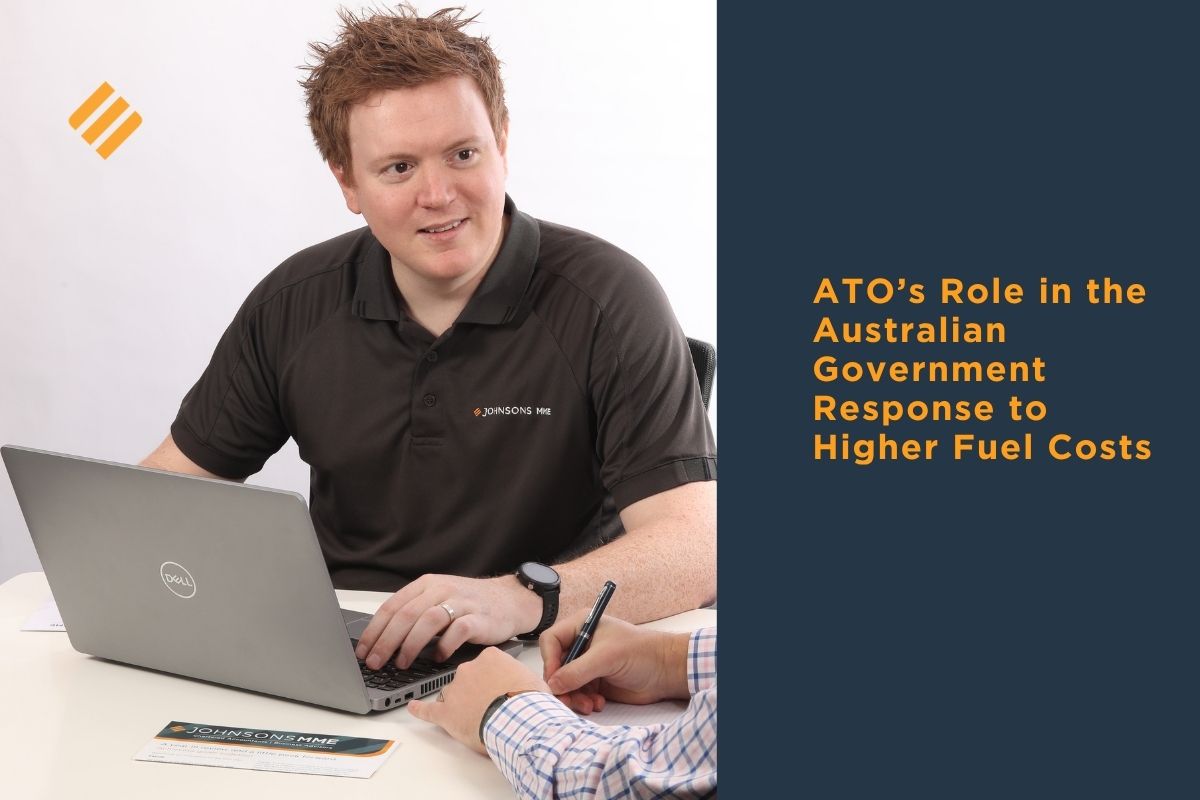 Johnsons MME accountant meeting with client at desk using laptop, discussing ATO fuel tax changes and higher fuel cost support in Australia 2026